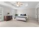 Main bedroom with tray ceiling, neutral carpet, and shuttered windows at 1380 Tennis Court Pl, Roswell, GA 30075