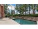 Inviting pool with a cascading waterfall and brick facade, perfect for relaxing and entertaining at 1380 Tennis Court Pl, Roswell, GA 30075
