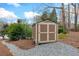 Well-maintained shed provides extra storage space on a gravel foundation in a wooded backyard at 1380 Tennis Court Pl, Roswell, GA 30075