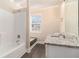 Clean bathroom with granite countertop vanity and shower-tub combo at 3552 Meadowview Dr, Lithia Springs, GA 30122