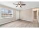Bright, carpeted bedroom with a ceiling fan and a large window at 3552 Meadowview Dr, Lithia Springs, GA 30122