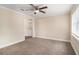 Bright, carpeted bedroom with a ceiling fan and ample natural light at 3552 Meadowview Dr, Lithia Springs, GA 30122