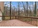 Wood deck overlooking wooded yard with mature trees in the background at 3552 Meadowview Dr, Lithia Springs, GA 30122
