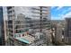 Stunning aerial view of the building with balconies and a rooftop pool overlooking the cityscape at 1065 Peachtree Ne St # 3105, Atlanta, GA 30309