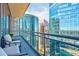 Condo balcony view with chairs and glass railing overlooking cityscape with many buildings at 1065 Peachtree Ne St # 3105, Atlanta, GA 30309