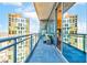 Spacious balcony with glass railings showcasing stunning views of the city skyline at 1065 Peachtree Ne St # 3105, Atlanta, GA 30309