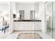 Elegant dual vanity bathroom featuring marble counters and white cabinets, with an open shower at 1065 Peachtree Ne St # 3105, Atlanta, GA 30309