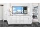 A double vanity in a well lit bathroom featuring granite countertops and cityscape reflection at 1065 Peachtree Ne St # 3105, Atlanta, GA 30309