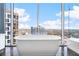 Sleek soaking tub in a modern bathroom with large windows and amazing city views at 1065 Peachtree Ne St # 3105, Atlanta, GA 30309