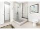 Modern tiled shower with glass enclosure, built-in bench, and contemporary fixtures at 1065 Peachtree Ne St # 3105, Atlanta, GA 30309