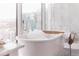 Inviting soaking tub with champagne and city views for a luxurious experience at 1065 Peachtree Ne St # 3105, Atlanta, GA 30309