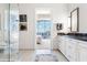 Elegant bathroom featuring marble counters, white cabinets, and a seamless glass shower at 1065 Peachtree Ne St # 3105, Atlanta, GA 30309