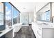 Bright bathroom boasts a soaking tub, glass shower, and vanity with city views at 1065 Peachtree Ne St # 3105, Atlanta, GA 30309