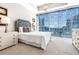 Bright, well-lit bedroom featuring a large window with stunning city views and contemporary furnishings at 1065 Peachtree Ne St # 3105, Atlanta, GA 30309