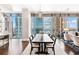 Elegant dining room with floor to ceiling windows, stylish chairs, and striking city view at 1065 Peachtree Ne St # 3105, Atlanta, GA 30309