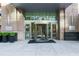 Building entrance with a revolving door, signage, and modern architectural details at 1065 Peachtree Ne St # 3105, Atlanta, GA 30309