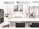 Close-up of kitchen with stainless steel appliances, white cabinets, and marble countertops at 1065 Peachtree Ne St # 3105, Atlanta, GA 30309