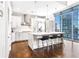 Modern white kitchen with stainless steel appliances, center island, and city view at 1065 Peachtree Ne St # 3105, Atlanta, GA 30309