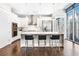 Bright kitchen with stainless steel appliances, white cabinetry, and a marble waterfall island with seating at 1065 Peachtree Ne St # 3105, Atlanta, GA 30309