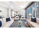 Bright living room with a stunning chandelier, comfortable seating, and city views at 1065 Peachtree Ne St # 3105, Atlanta, GA 30309