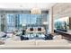 Bright living room with city views, modern chandelier, and stone accent wall with a fireplace at 1065 Peachtree Ne St # 3105, Atlanta, GA 30309