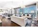 Open concept living space with modern furnishings, floor-to-ceiling windows, and a city skyline view at 1065 Peachtree Ne St # 3105, Atlanta, GA 30309