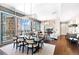 Open concept living space with dining and living area, featuring floor-to-ceiling windows and hardwood floors at 1065 Peachtree Ne St # 3105, Atlanta, GA 30309