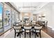 Open concept living and dining area with hardwood floors and large windows overlooking city views at 1065 Peachtree Ne St # 3105, Atlanta, GA 30309