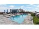 Rooftop pool area with skyline views, lounge seating, and blue umbrellas at 1065 Peachtree Ne St # 3105, Atlanta, GA 30309