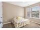 Bedroom featuring a large window, carpet flooring and a yellow-themed bed at 2258 Bigwood Trail Trl, Atlanta, GA 30349