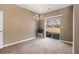 Bright dining room featuring plush carpeting, natural light from a sliding glass door, and elegant lighting at 2258 Bigwood Trail Trl, Atlanta, GA 30349