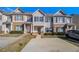 Inviting townhome exterior featuring a private parking area and manicured shrubbery for enhanced curb appeal at 2258 Bigwood Trail Trl, Atlanta, GA 30349