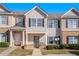 Charming townhome with neutral siding, black shutters and tidy landscaping creating a welcoming curb appeal at 2258 Bigwood Trail Trl, Atlanta, GA 30349