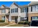 Attractive townhome with complementary siding, shutters, manicured landscaping, and inviting curb appeal at 2258 Bigwood Trail Trl, Atlanta, GA 30349