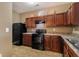 Traditional kitchen offering black appliances, brown cabinets, and neutral countertops at 2258 Bigwood Trail Trl, Atlanta, GA 30349