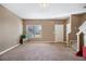 Inviting living room showcasing neutral walls, soft carpeting, natural light and stair access to the upper level at 2258 Bigwood Trail Trl, Atlanta, GA 30349