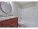 Bathroom featuring a vanity with granite countertops, white tiled shower and tub, and modern fixtures at 4206 Santa Fe Pkwy, Atlanta, GA 30350