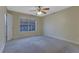 Carpeted bedroom featuring neutral paint, base molding, and a window for ample natural light at 4206 Santa Fe Pkwy, Atlanta, GA 30350