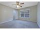 Bedroom features neutral walls, carpet, ceiling fan, and a window offering natural light at 4206 Santa Fe Pkwy, Atlanta, GA 30350