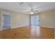 Bright bedroom with hardwood floors, ceiling fan, and sliding glass doors leading to an outdoor space at 4206 Santa Fe Pkwy, Atlanta, GA 30350