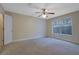 Bright bedroom with carpet, ceiling fan, and large window bringing in natural light, creating a welcoming space at 4206 Santa Fe Pkwy, Atlanta, GA 30350