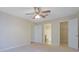 Beige bedroom featuring a ceiling fan, carpet, and doorways to the bathroom and walk-in closet at 4206 Santa Fe Pkwy, Atlanta, GA 30350