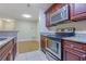 Kitchen with stainless appliances, granite countertops, and wood cabinets overlooking the living room at 4206 Santa Fe Pkwy, Atlanta, GA 30350