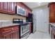 Kitchen featuring granite countertops, stainless steel appliances, and wood cabinets at 4206 Santa Fe Pkwy, Atlanta, GA 30350