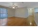 Inviting living room with hardwood floors, ceiling fan, and a sliding glass door providing natural light and outdoor access at 4206 Santa Fe Pkwy, Atlanta, GA 30350