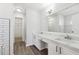 Bright bathroom featuring a double sink vanity with white cabinets and a large mirror at 8026 Rivermont Ct, Snellville, GA 30039