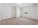 This bedroom features neutral carpet, a window, and a closet at 8026 Rivermont Ct, Snellville, GA 30039