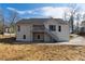 Back of home featuring a deck, stairs, and plenty of yard space at 8026 Rivermont Ct, Snellville, GA 30039