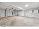 Spacious two car garage featuring a concrete floor and storage shelves at 8026 Rivermont Ct, Snellville, GA 30039