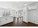 Open kitchen with white cabinets, stainless steel appliances, and an eat-in bar area at 8026 Rivermont Ct, Snellville, GA 30039